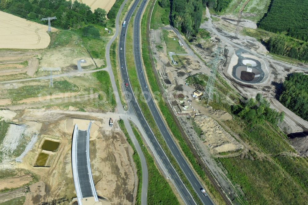 Rötha from the bird's eye view: Finished bridge construction and stormwater retention tanks and fire water pond - Highway- Construction site with earthworks along the route and of the route of the highway route B95 to A72 motorway in Roetha in the state Saxony