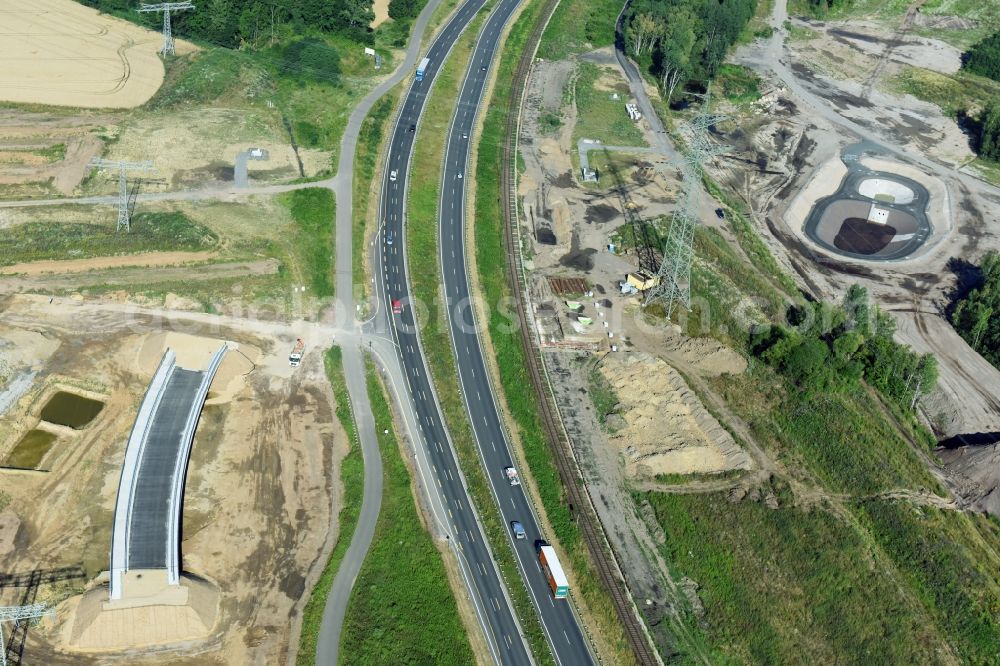 Aerial image Rötha - Finished bridge construction and stormwater retention tanks and fire water pond - Highway- Construction site with earthworks along the route and of the route of the highway route B95 to A72 motorway in Roetha in the state Saxony