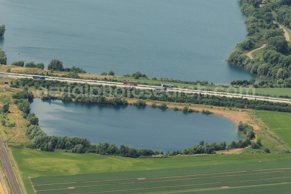 Aerial photograph Windehausen - In Windeshausen in Thuringia the A38 motorway crosses two former gravel surface mines the Bielener gravel waters to which the Moewensee heard