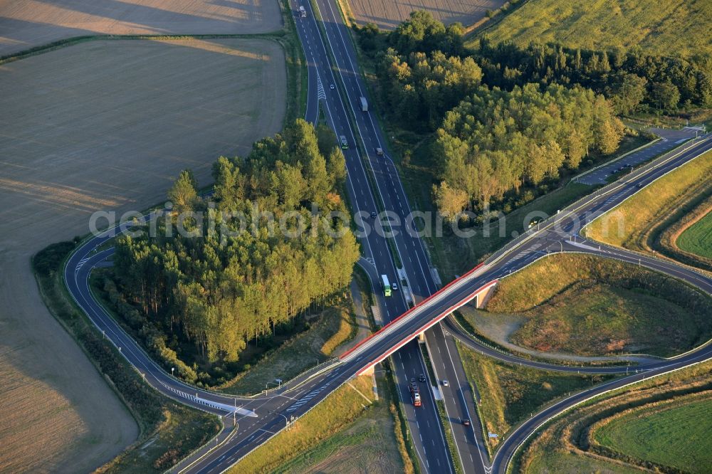 Fehrbellin from the bird's eye view: Routing and traffic lanes over the highway bridge in the motorway A at the exit Neuruppin-Sued in Fehrbellin in the state Brandenburg