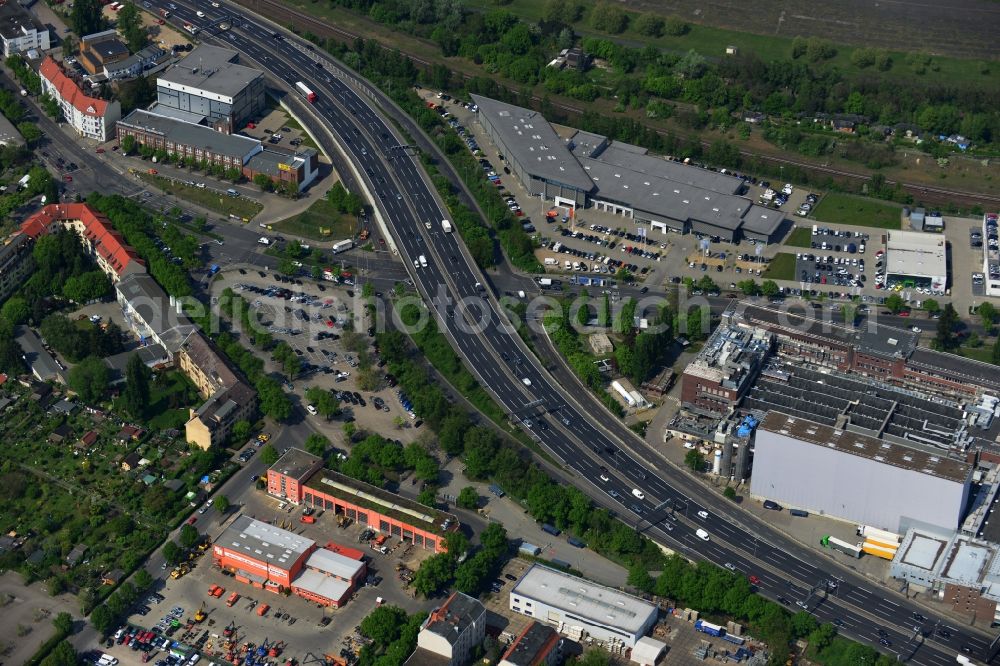 Berlin from above - The A100 motorway passes through the city district of Berlin-Tempelhof Berlin. At the height of the bridge over the Oberlandstraae an inner city industrial area has developed on the 'highway. Companies like Volkswagen Automobile GmbH Berlin, Germany Gillette GmbH, Lemberg food and Pickens Self Storage Berlin Tempelhof have their offices here