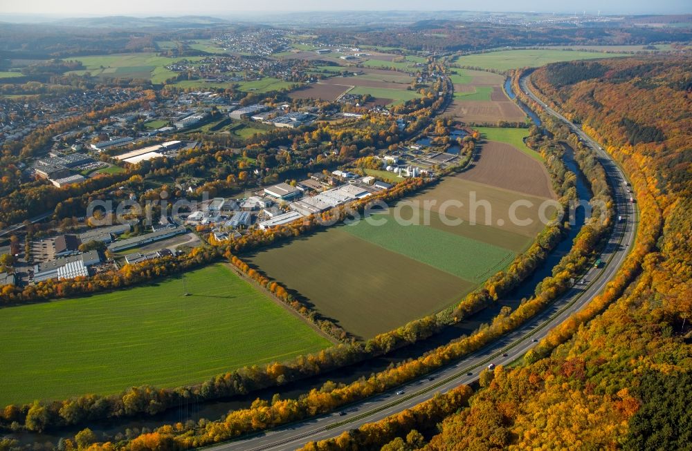 Aerial photograph Neheim - Course of the federal motorway A 46 along the river Ruhr in the North of Neheim in the state of North Rhine-Westphalia. Agricultural fields and autumnal forest ist located along the motorway and the river