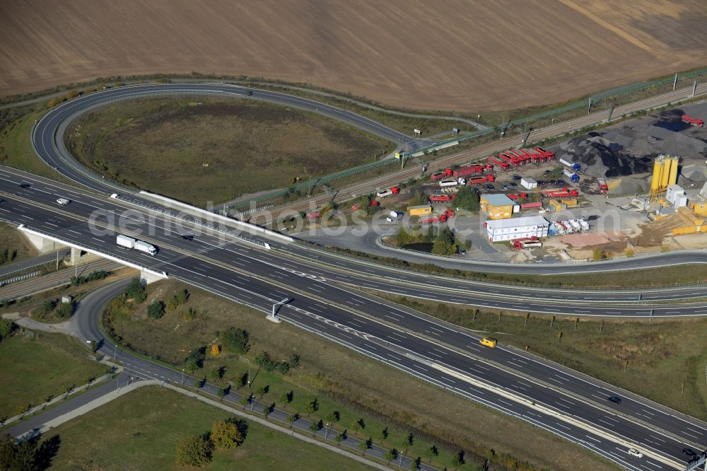 Waltersdorf from above - Course of the federal motorway A113 in Waltersdorf in the state of Brandenburg. The works of the concrete producer AMBB GmbH are located adjacent to the road and the Berliner Chaussee street