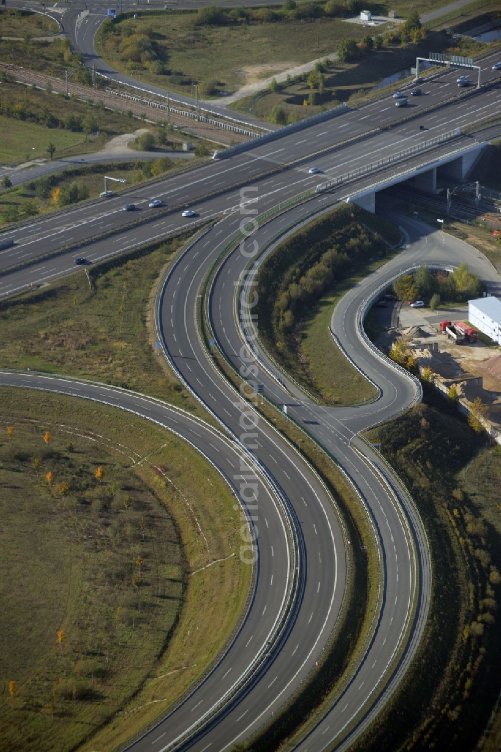 Schönefeld from the bird's eye view: Course of the federal motorway A113 in Waltersdorf in the state of Brandenburg. The works of the concrete producer AMBB GmbH are located adjacent to the road and the Berliner Chaussee street