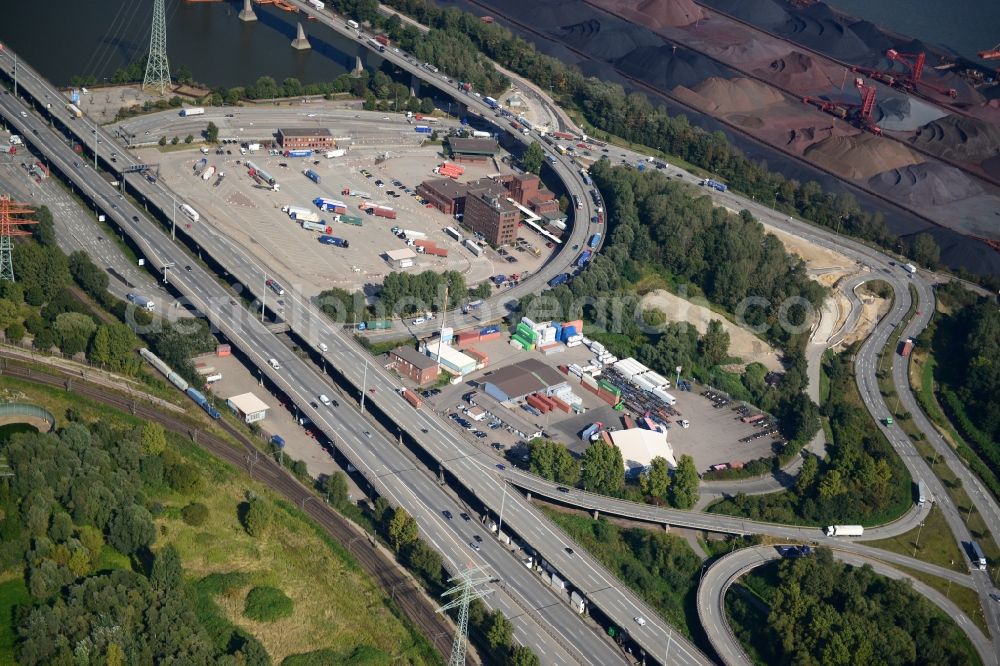 Aerial photograph Hamburg - Motorway exit slip road A7 HH-Waltershof, the course of curve on the Finkenwerder road and Waltershof customs office in Hamburg-Mitte. A project of the Hamburg Port Authority HPA