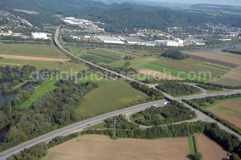 Schwemlingen Stadt Merzig from the bird's eye view: Blick aus Westen über die Autobahnausfahrt 5 Merzig-Schwemlingen der Autobahn A8 und die Saar auf das Gewerbegebiet Wiesenhof in Besseringen.