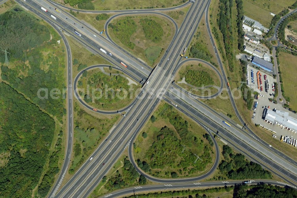 Ludwigsfelde from above - Intersection Ludwigsfelde-Ost in Ludwigsfelde in the state of Brandenburg. The interchange connects the federal road B101 and the federal motorway A10. It is located amidst commercial areas and meadows near a forest