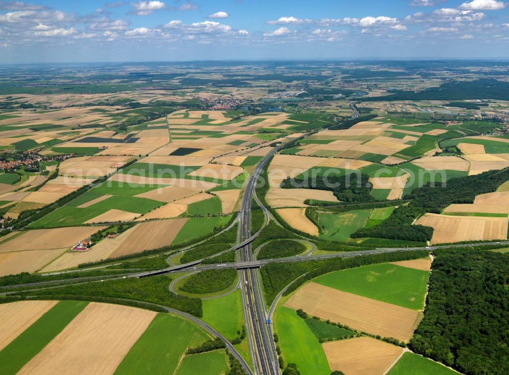 Biebelried from the bird's eye view: Motorway junction Biebelried in the borough of Biebelried in the state of Bavaria. The interchange connects in a clover-leaf shape the federal motorways A3 and A7. The motorway interchange is surrounded by fields in the North of the namegiving borough