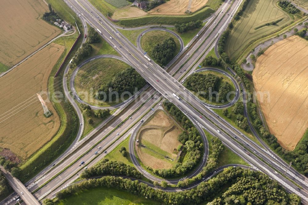 Aerial image Dortmund - View at the motorway intersection Dortmund-West in Dortmund in North Rhine-Westphalia. It connects the Highways A 40 and A 45 with each other. The cross has a cloverleaf shape and is located right on Indupark. Responsible is the state owned Straßen.NRW