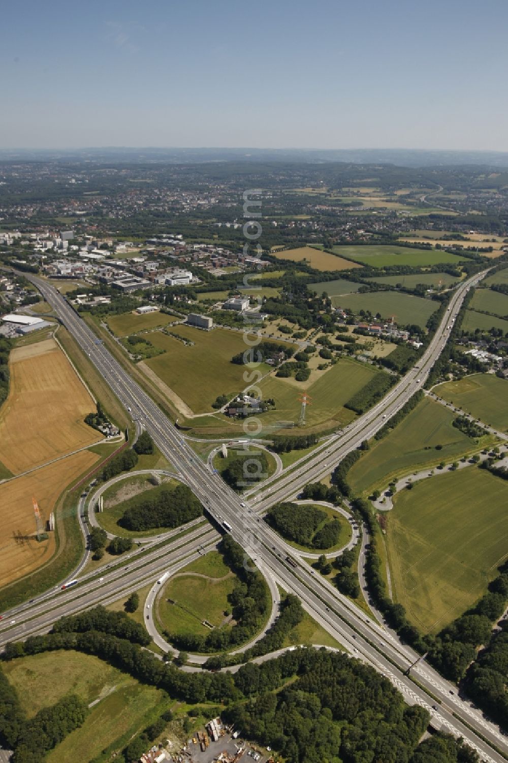 Aerial image Dortmund - View at the motorway intersection Dortmund-West in Dortmund in North Rhine-Westphalia. It connects the Highways A 40 and A 45 with each other. The cross has a cloverleaf shape and is located right on Indupark. Responsible is the state owned Strassen.NRW