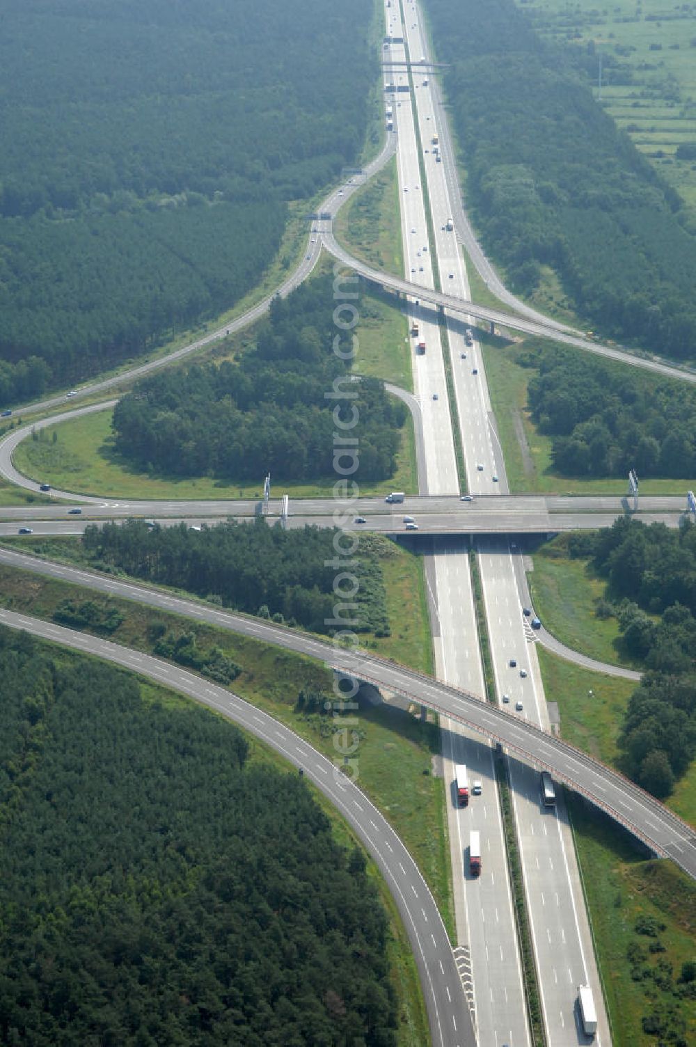 Schönefeld from above - Blick auf das Autobahnkreuz Schönefeld. Das Schönefelder Kreuz (umgangssprachlich auch Kreuz Schönefeld) ist ein Autobahnkreuz am südlichen Berliner Ring (A 10), der nach Süden die A 13 Dresden und nach Norden die A 113 Berlin anbindet. Das Kreuz wurde ursprünglich in der verbreiteten Kleeblattform errichtet, wobei drei sehr enge Kreisel (Tempo: 20 bis 40 km/h) gesetzt wurden, bis zur Wende fehlte sogar eine Tangente (Durchfahren von drei Kreiseln notwendig). Lediglich der Kreisel im nordwestlichen Quadranten des Autobahnkreuzes wurde überdimensioniert - in Relation zum gesamten Autobahnkreuz - errichtet. Der Umbau des Schönefelder Kreuzes in den 1990ern brachte eine Mischform hervor, die in Richtung eines Malteserkreuzes geht, der Wechsel Nord nach Ost und Süd nach West hat jedoch weiterhin enge Kreisel.