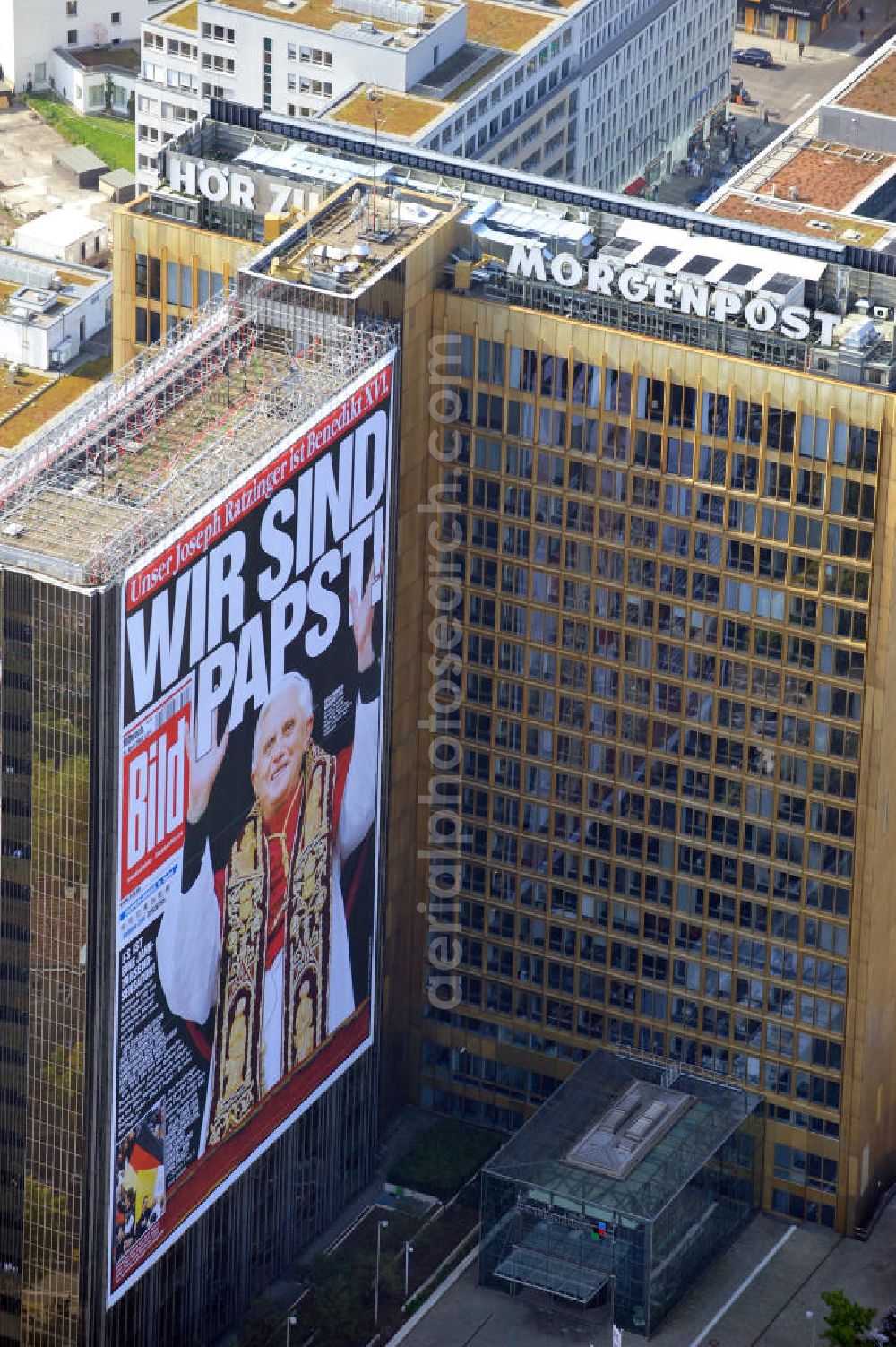 Berlin Kreuzberg from the bird's eye view: Verlagsgebäude Axel-Springer-Haus geschmückt mit der Tietelseite der Bildzeitung vom Tag nach der Wahl von Joseph Ratzinger zum Papst Benedikt XVI in Berlin-Kreuzberg. Publisher building Axel-Springer-Haus decorated with the cover of the newspaper Bild from the day after the election of Joseph Ratzinger to Pope Benedict XVI in Berlin-Kreuzberg.