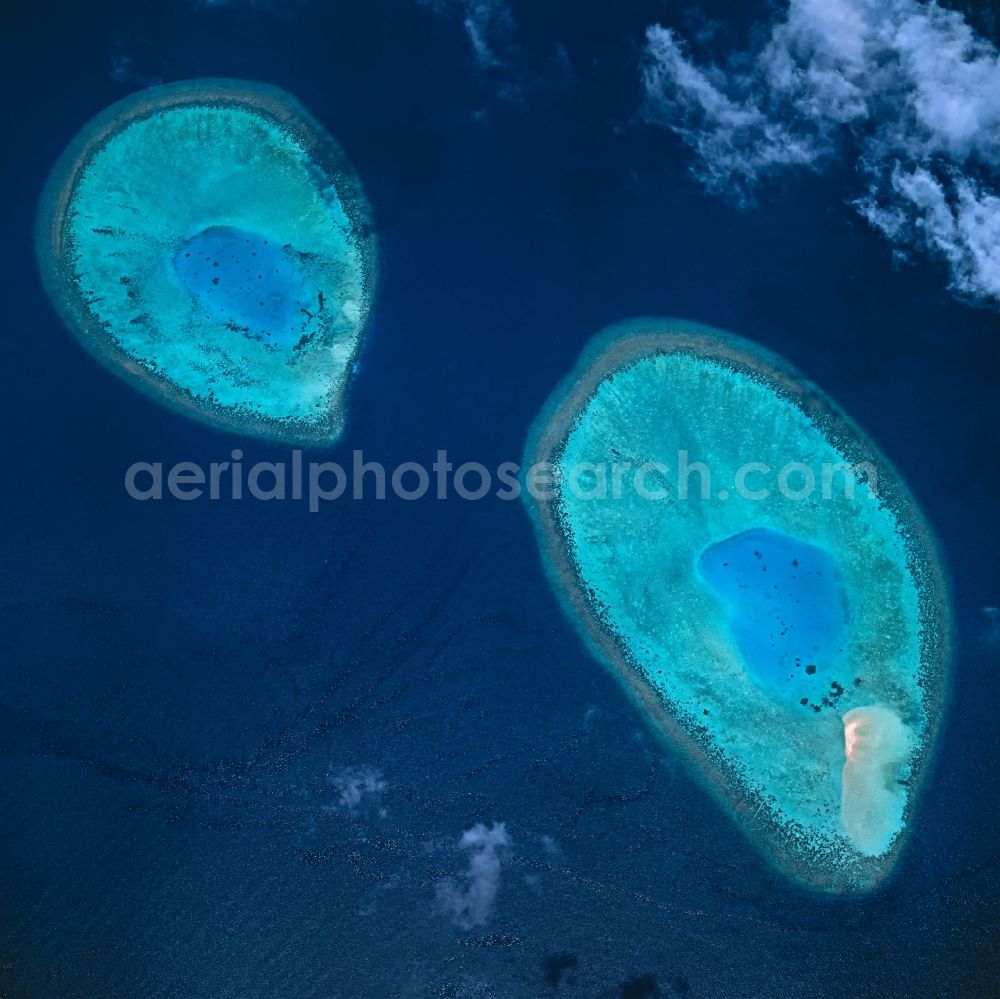 Aerial photograph Goidhoo - Baa Atoll on the water surface Arabian Sea in Goidhoo in North Province, Maldives. Baa Atoll, Maldives Two of 105 coral reefs of the Baa-Atoll in the dark blue water of the Indian Ocean. The limestone reefs are built by corals and surround a small lagoon. Baa Atoll is a UNESCO World Biosphere Reserve