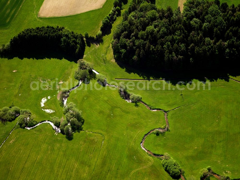 Thurmansbang from the bird's eye view: The creek Grosse Ohe in Thurmansbang in the state of Bavaria. The creek runs in the West of Kneisting through agricultural fields and between trees and meets the Auerbach