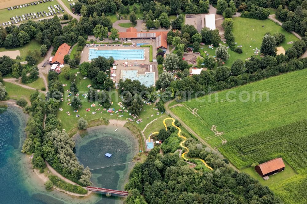 Mammendorf from above - Outdoor pool and amusement park Mammendorfer See near Fuerstenfeldbruck in the state of Bavaria, Germany. Mass influx of bathers on the beach and the shore area of a??a??the bathing lake and the sunbathing areas of the swimming pool with water slide