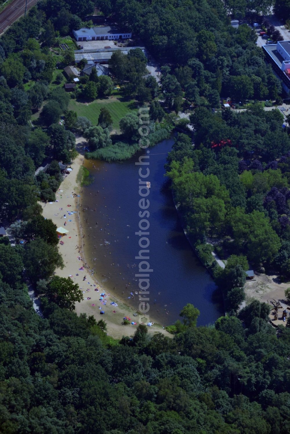 Berlin from the bird's eye view: View of the swimming lake of the FEZ-Berlin with bathing people in the forest park in the Berliner Wuhlheide