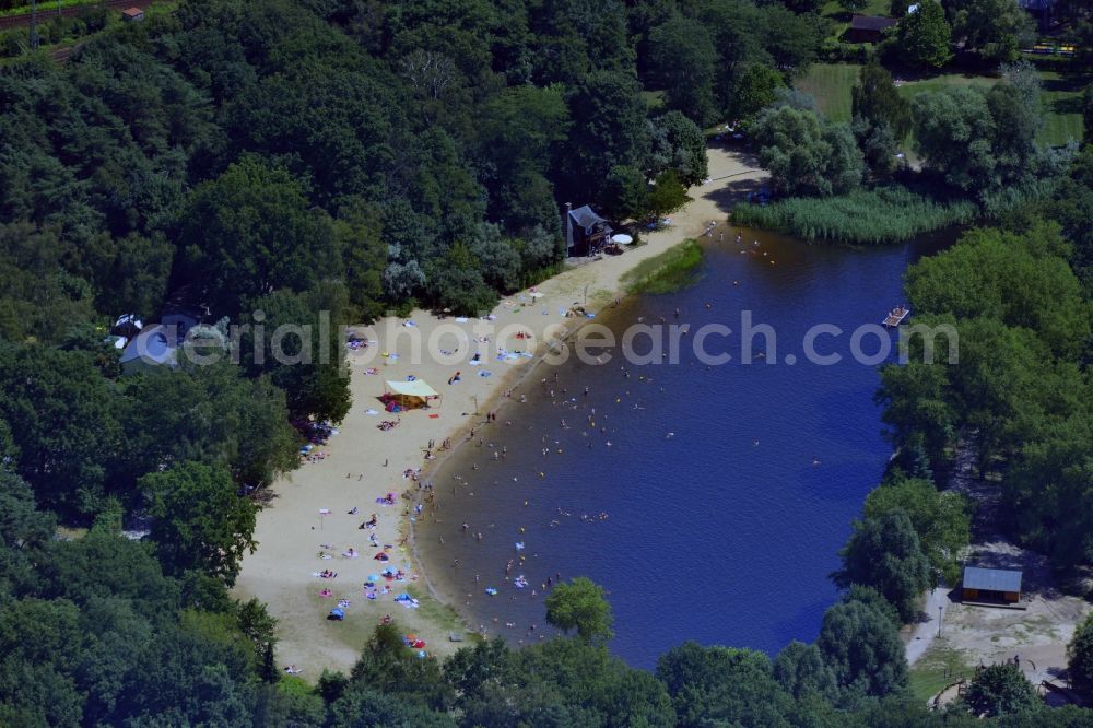 Aerial image Berlin - View of the swimming lake of the FEZ-Berlin with bathing people in the forest park in the Berliner Wuhlheide