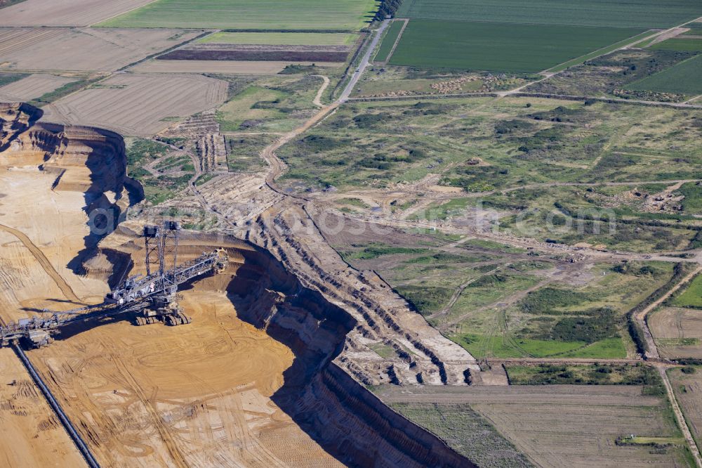 Erkelenz from above - Excavator conveyor bridge in the seam of the mining area and the overburden areas in the brown coal opencast mine on the Luetzerath road in Erkelenz in the state of North Rhine-Westphalia, Germany