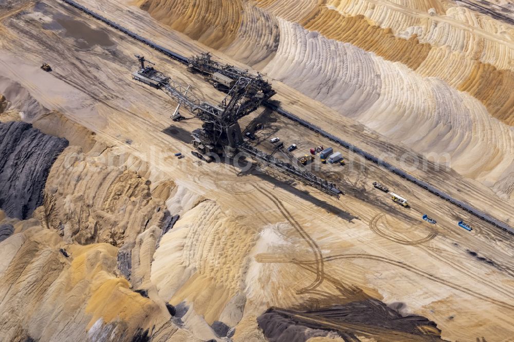 Jüchen from above - Excavator conveyor bridge in the seam of the mining area and the overburden areas in the lignite opencast mine of RWE Power in the northern Rhenish lignite mining area in Juechen in the federal state of North Rhine-Westphalia, Germany