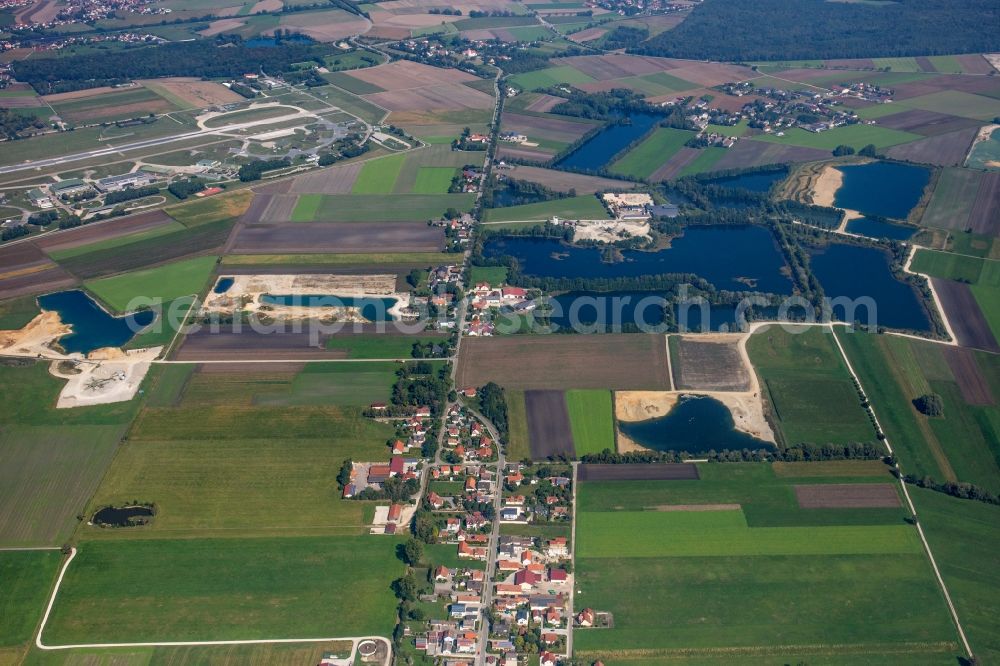 Rosing from above - Lake shore and overburden areas of the quarry lake and gravel open pit of Donaumoos Kies GmbH & Co. KG in Rosing in the state Bavaria, Germany