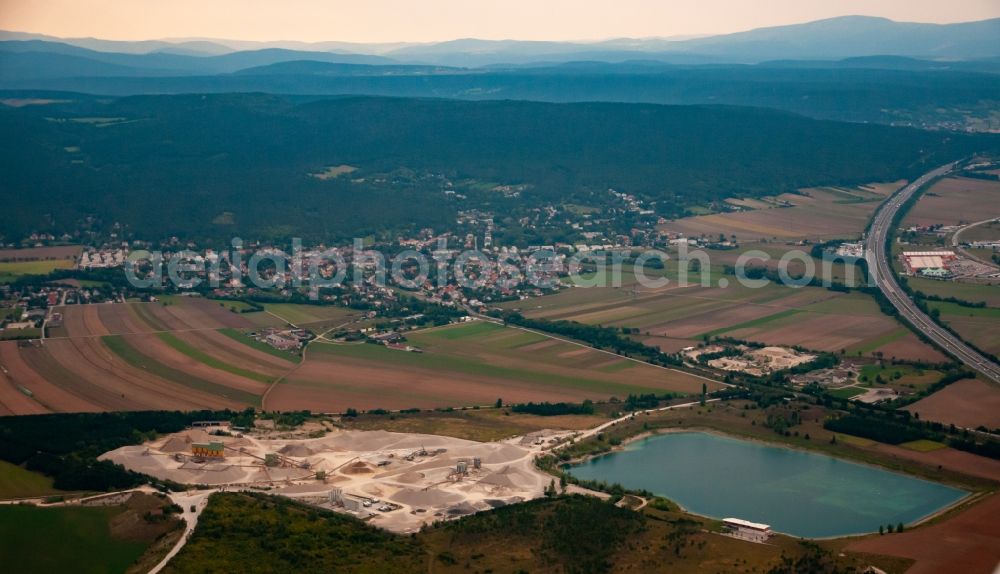 Brunn an der Schneebergbahn from above - Lake shore and overburden areas of the quarry lake and gravel open pit ROHRDORFER Kieswerk in Bad Fischau in Lower Austria, Austria