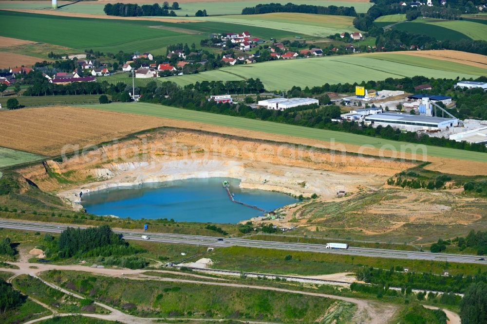 Wernsdorf from the bird's eye view: Lake shore and overburden areas of the quarry lake and gravel open pit - Sandgrube in Wernsdorf in the state Saxony, Germany