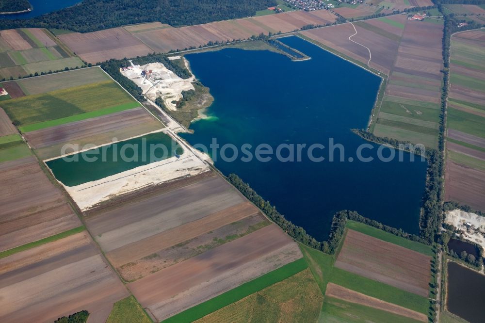 Aerial photograph Weichering - Lake shore and overburden areas of the quarry lake and gravel open pit of DMK Donaumoos Kies GmbH & Co. KG in Weichering in the state Bavaria, Germany