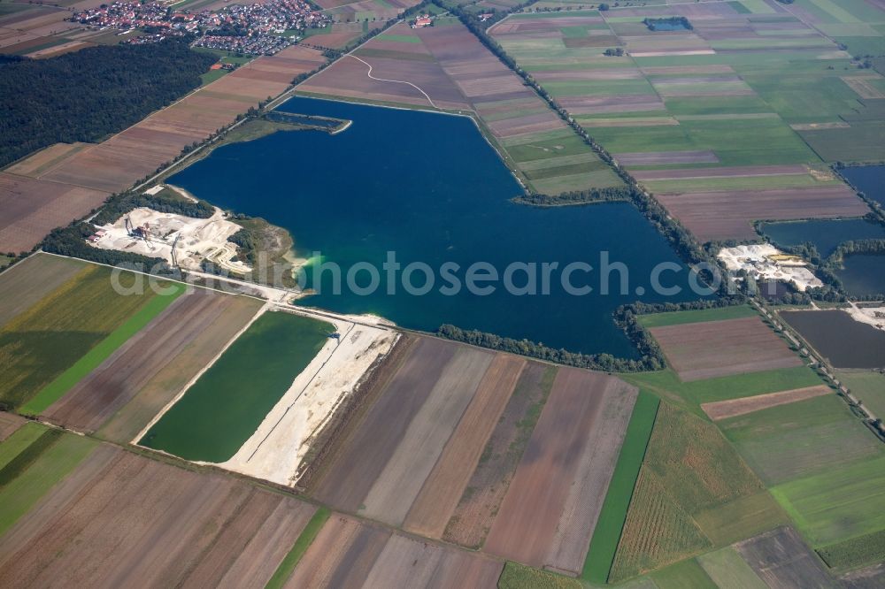 Weichering from the bird's eye view: Lake shore and overburden areas of the quarry lake and gravel open pit of DMK Donaumoos Kies GmbH & Co. KG in Weichering in the state Bavaria, Germany