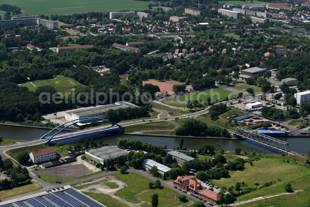 Aerial image Genthin - Railway bridge and blue steel arc bridge with the federal road B1 across the Elbe-Havel-Canal in the Northeast of Genthin in the state of Saxony-Anhalt. Genthin is located in the background