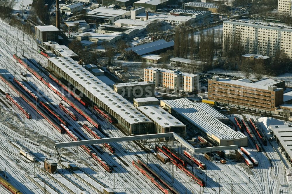 Aerial image Berlin - Wintry snowy terrain railway depot and repair shop for maintenance and repair of trains of passenger transport destrict Lichtenberg in Berlin in Germany