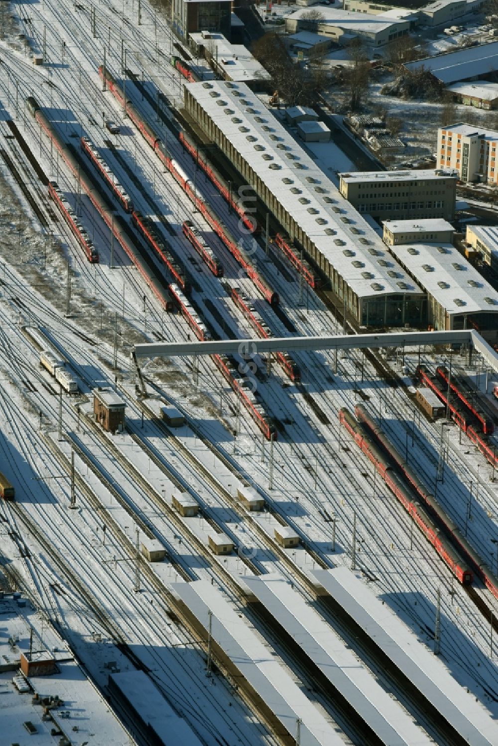 Aerial photograph Berlin - Wintry snowy terrain railway depot and repair shop for maintenance and repair of trains of passenger transport destrict Lichtenberg in Berlin in Germany