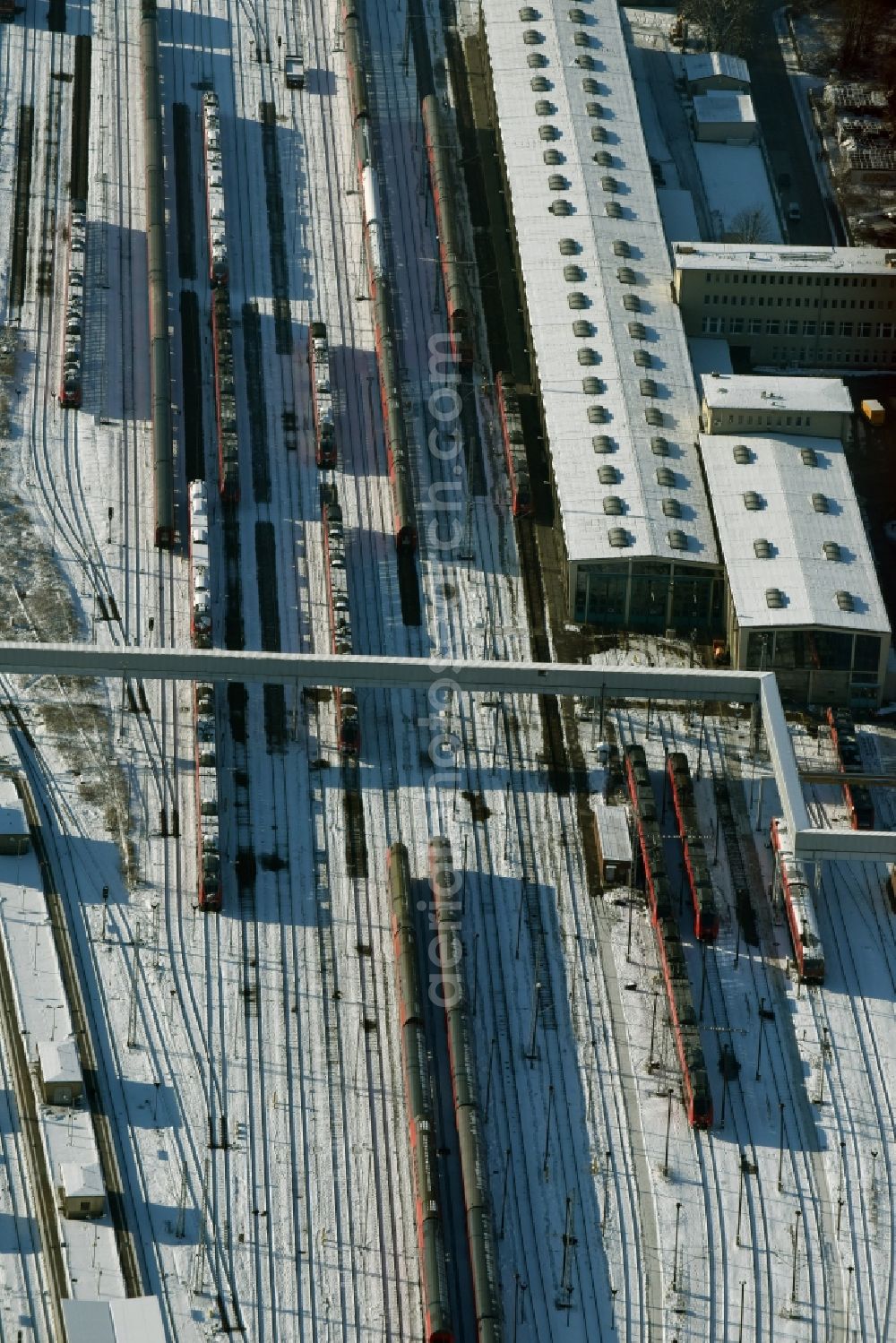 Berlin from above - Wintry snowy terrain railway depot and repair shop for maintenance and repair of trains of passenger transport destrict Lichtenberg in Berlin in Germany