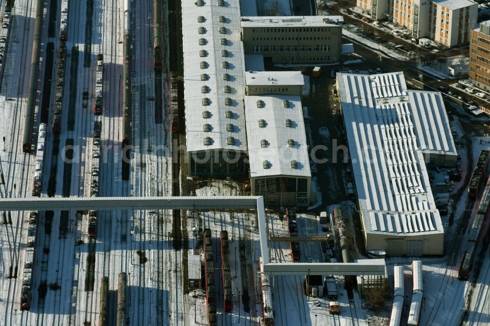 Aerial image Berlin - Wintry snowy terrain railway depot and repair shop for maintenance and repair of trains of passenger transport destrict Lichtenberg in Berlin in Germany