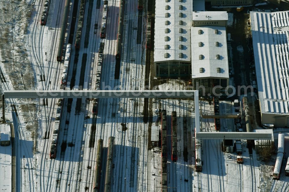 Aerial photograph Berlin - Wintry snowy terrain railway depot and repair shop for maintenance and repair of trains of passenger transport destrict Lichtenberg in Berlin in Germany