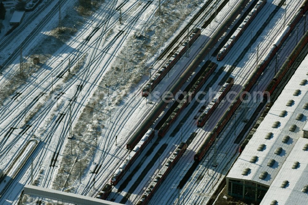 Berlin from above - Wintry snowy terrain railway depot and repair shop for maintenance and repair of trains of passenger transport destrict Lichtenberg in Berlin in Germany