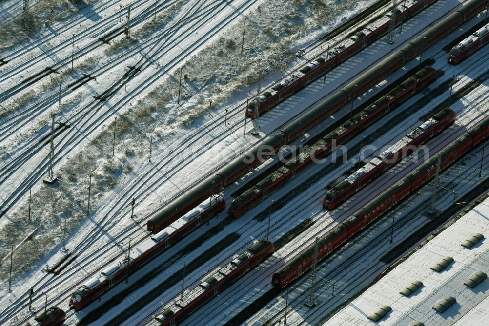 Berlin from the bird's eye view: Wintry snowy terrain railway depot and repair shop for maintenance and repair of trains of passenger transport destrict Lichtenberg in Berlin in Germany