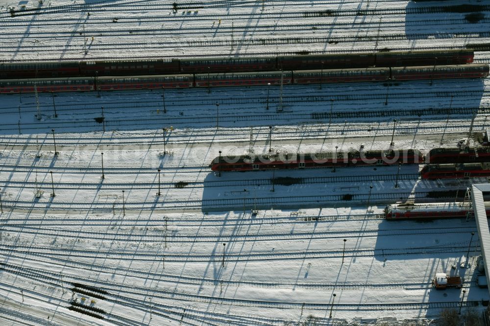 Aerial image Berlin - Wintry snowy terrain railway depot and repair shop for maintenance and repair of trains of passenger transport destrict Lichtenberg in Berlin in Germany