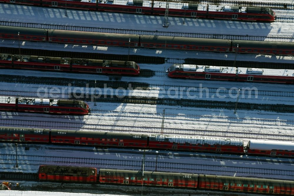 Berlin from above - Wintry snowy terrain railway depot and repair shop for maintenance and repair of trains of passenger transport destrict Lichtenberg in Berlin in Germany