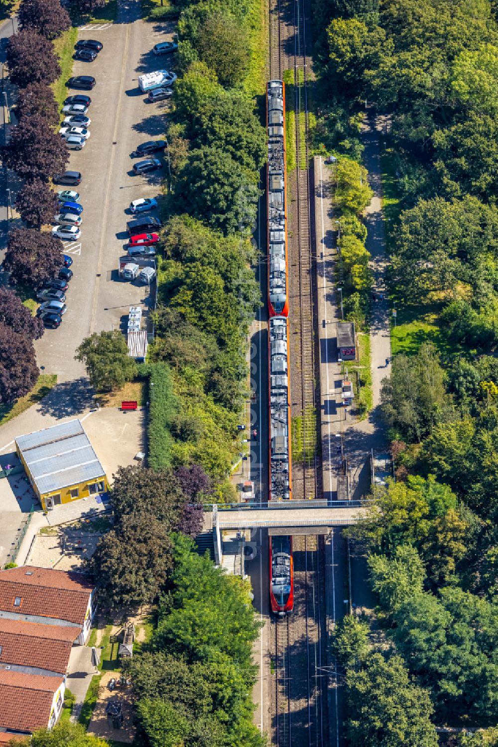 Gevelsberg from the bird's eye view: Station building and track systems of the S-Bahn station with train of Deutschen Bahn and pedestrian bridge at Burbecker street in Gevelsberg in the state North Rhine-Westphalia