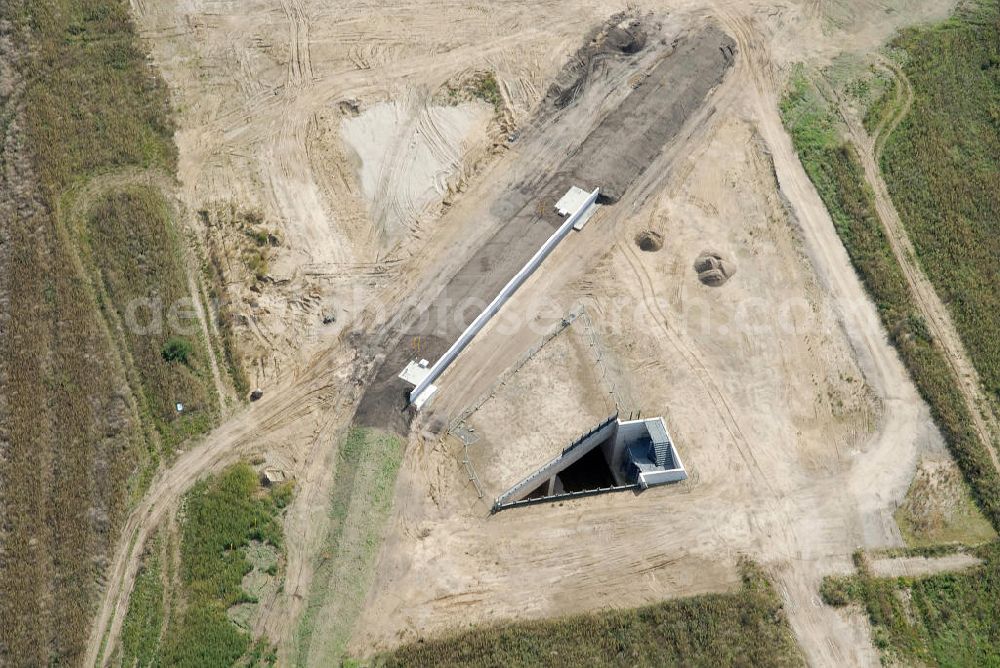 Schönefeld from the bird's eye view: Bau der Trogbaugrube am Flughafen Schönefeld, BBI. Die Trogbauwerke in offener Bauweise, dienen dem Ausbau des Schienennetzes der Deutschen Bahn AG am BBI- Flughafen. Bauherr ist DB Netz. Construction of the trough excavation at the airport Schönefeld BBI. The excavation in open cut, are used to expand the rail network of Deutsche Bahn AG on BBI airport. Building owner is the DB network.