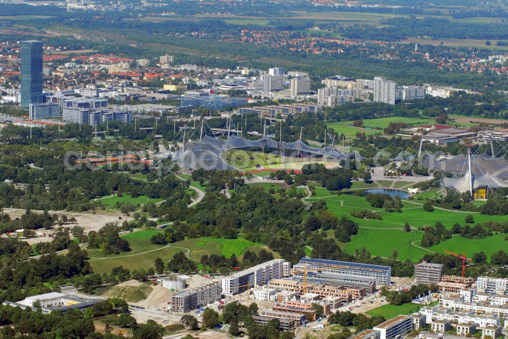 München from above - Baustelle der Wohnanlage Ackermannstraße und Olympiapark mit Blick auf das Olympiastadion München. Im hinteren linken Bildrand ist der höchste Bürokomplex der Stadt, das Uptown, zu sehen. Kontakt: cf Claudia Fischer Architekten, kaiserplatz 12 80803 München, Tel. +49(0)89 33066 265, Fax +49(0)89 33066 267, Email: cfarchitekten@gmx.net; Olympiapark München GmbH, Spiridon-Louis-Ring 21, 80809 München, Tel. +49(0)8930 67 0, Fax +49(0)8930 6722 22, Email: info@olympiapark-muenchen.de; Uptwon: Ingenhoven Architekten, Plange Mühle 1, 40221 Düsseldorf, Tel. +43(0)211 30101 01, Fax +43(0)211 30101 31, Email: info@ingenhovenarchitekten.de; ATP Architekten und Ingenieure, Innsbruck, Heiliggeiststr. 16, A 6020 Innsbruck, Tel. +43(0)512 261 870, Fax +43(0)512 261 864, Email: info@atp.ag; Wayss & Freytag Schlüsselfertigbau AG Geschäftsbereich Allgemeiner Hochbau, Eschborner Landstraße 55, 60489 Frankfurt am Main, Tel. +49(0)69 97901 0, Fax +49(0)69 97901 750, Email: info@wf-sfbau.de