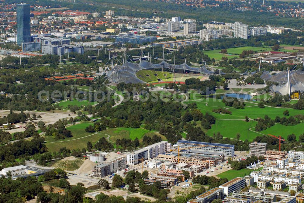 München from the bird's eye view: Baustelle der Wohnanlage Ackermannstraße und Olympiapark mit Blick auf das Olympiastadion München. Im hinteren linken Bildrand ist der höchste Bürokomplex der Stadt, das Uptown, zu sehen. Kontakt: cf Claudia Fischer Architekten, kaiserplatz 12 80803 München, Tel. +49(0)89 33066 265, Fax +49(0)89 33066 267, Email: cfarchitekten@gmx.net; Olympiapark München GmbH, Spiridon-Louis-Ring 21, 80809 München, Tel. +49(0)8930 67 0, Fax +49(0)8930 6722 22, Email: info@olympiapark-muenchen.de; Uptwon: Ingenhoven Architekten, Plange Mühle 1, 40221 Düsseldorf, Tel. +43(0)211 30101 01, Fax +43(0)211 30101 31, Email: info@ingenhovenarchitekten.de; ATP Architekten und Ingenieure, Innsbruck, Heiliggeiststr. 16, A 6020 Innsbruck, Tel. +43(0)512 261 870, Fax +43(0)512 261 864, Email: info@atp.ag; Wayss & Freytag Schlüsselfertigbau AG Geschäftsbereich Allgemeiner Hochbau, Eschborner Landstraße 55, 60489 Frankfurt am Main, Tel. +49(0)69 97901 0, Fax +49(0)69 97901 750, Email: info@wf-sfbau.de