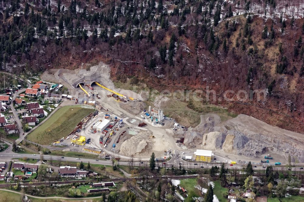 Aerial image Oberau - Construction work at the North junction at the Magdalena Tunnel Oberau in the state of Bavaria. As part of the site bypass, the road tunnel will relieve the municipality of Oberau from traffic. The construction site includes concrete mixing plant, overburden warehouse, workshop building, container for accommodation and administration, ventilation equipment, wheel loader, dump truck. The construction is carried out by Marti Holding, planning by Highway Directorate South Bavaria