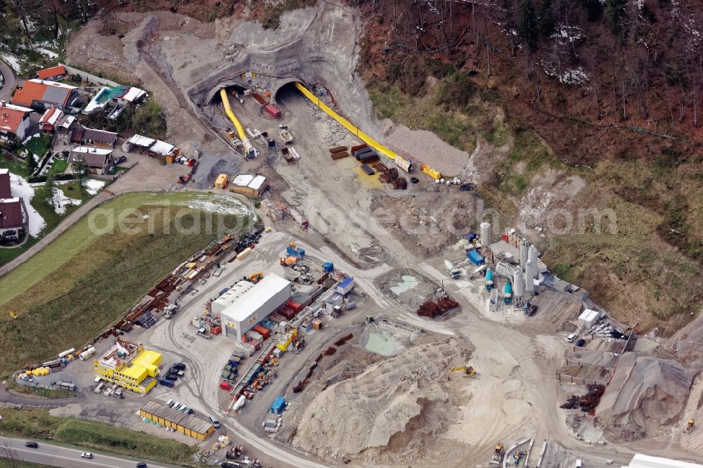 Aerial photograph Oberau - Construction work at the North junction at the Magdalena Tunnel Oberau in the state of Bavaria. As part of the site bypass, the road tunnel will relieve the municipality of Oberau from traffic. The construction site includes concrete mixing plant, overburden warehouse, workshop building, container for accommodation and administration, ventilation equipment, wheel loader, dump truck. The construction is carried out by Marti Holding, planning by Highway Directorate South Bavaria