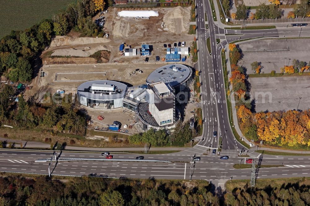 Brunnthal from the bird's eye view: Construction site of the adventure center Jochen Schweizer Arena in Taufkirchen in the state of Bavaria. The adventure worlds include surfing, body flying - flying in the wind tunnel, climbing in the high ropes course and gastronomy. The layout of the joint project of the Jochen Schweizer Group and the Airbus Group is reminiscent of a propeller. Execution OSA Ochs Schmidhuber Architekten