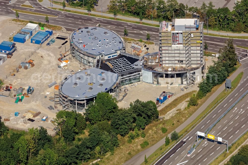 Brunnthal from above - Construction site of the adventure center Jochen Schweizer Arena in Taufkirchen in the state of Bavaria. The adventure worlds include surfing, body flying - flying in the wind tunnel, climbing in the high ropes course and gastronomy. The layout of the joint project of the Jochen Schweizer Group and the Airbus Group is reminiscent of a propeller. Execution OSA Ochs Schmidhuber Architekten