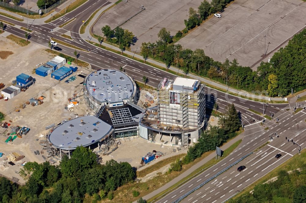 Brunnthal from the bird's eye view: Construction site of the adventure center Jochen Schweizer Arena in Taufkirchen in the state of Bavaria. The adventure worlds include surfing, body flying - flying in the wind tunnel, climbing in the high ropes course and gastronomy. The layout of the joint project of the Jochen Schweizer Group and the Airbus Group is reminiscent of a propeller. Execution OSA Ochs Schmidhuber Architekten