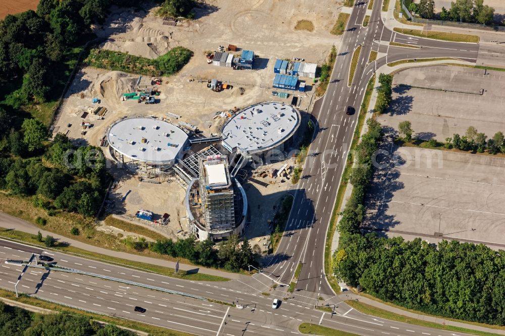 Aerial photograph Brunnthal - Construction site of the adventure center Jochen Schweizer Arena in Taufkirchen in the state of Bavaria. The adventure worlds include surfing, body flying - flying in the wind tunnel, climbing in the high ropes course and gastronomy. The layout of the joint project of the Jochen Schweizer Group and the Airbus Group is reminiscent of a propeller. Execution OSA Ochs Schmidhuber Architekten