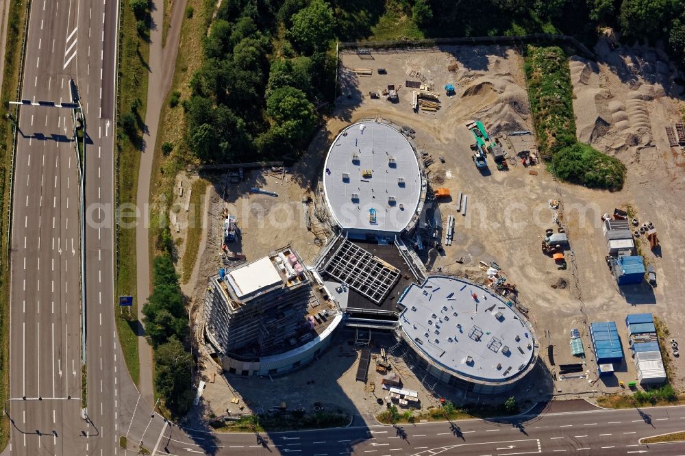 Brunnthal from above - Construction site of the adventure center Jochen Schweizer Arena in Taufkirchen in the state of Bavaria. The adventure worlds include surfing, body flying - flying in the wind tunnel, climbing in the high ropes course and gastronomy. The layout of the joint project of the Jochen Schweizer Group and the Airbus Group is reminiscent of a propeller. Execution OSA Ochs Schmidhuber Architekten