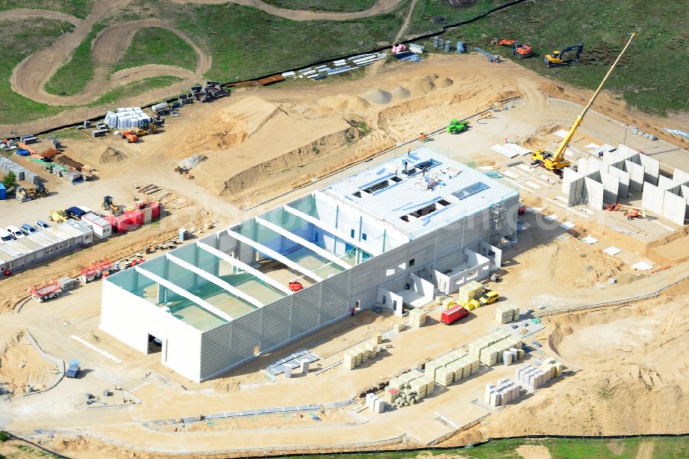 Aerial image Schwerin - Construction works of a building of CVP in the Industrial Park Schwerin in Schwerin in the state of Mecklenburg - Western Pomerania. The newly developed industrial and commercial area is currently under construction in a forest area in the South of Schwerin. A building of CVP Clean Value Plastics is being developed on site